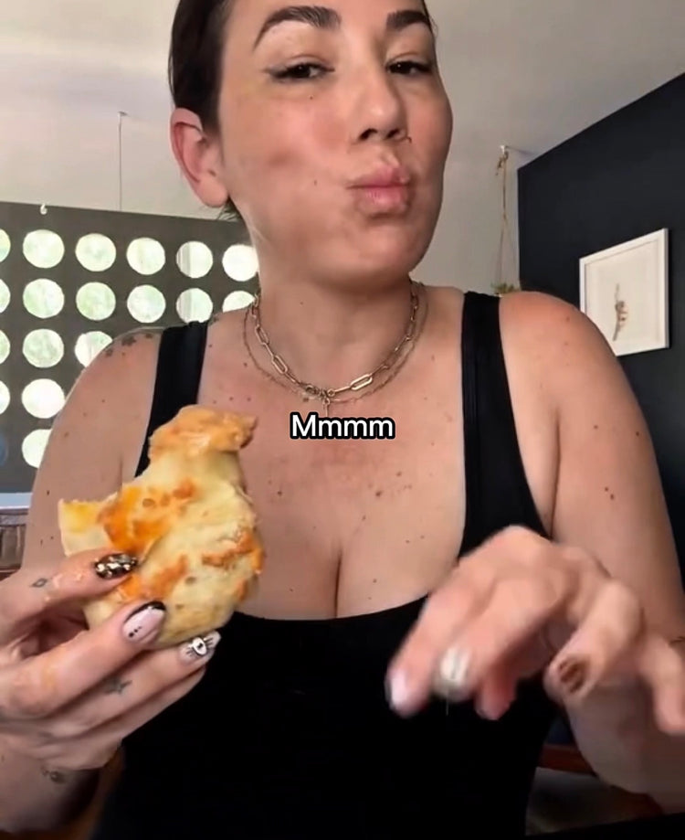 A Bad Hambres customer holding a burrito for a review with text: "Mmmm"