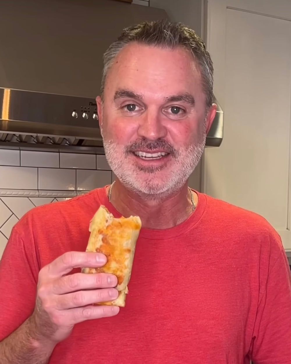 A Bad Hambres customer in a red shirt, holding a burrito