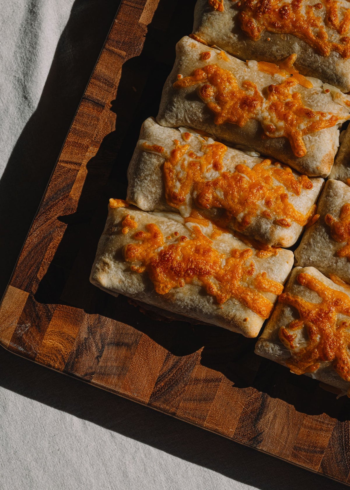 Angled shot of Bad Hambres burritos on a cutting board