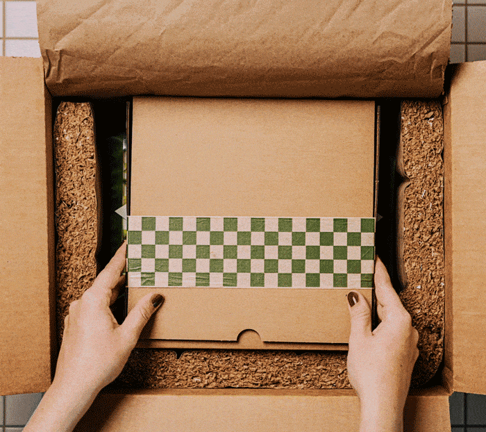 Two 6 pack Bad Hambres burrito packages being packed into a shipping box